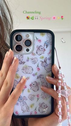 a woman is holding up her phone case with the cover on it's side