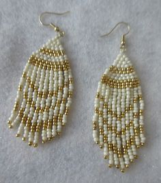 These fringe style earrings are handmade by me, Janet J. Griffen...  They are made with #11 glass seed beads...  The colors are white and gold glass seed beads and beaded with Nymo thread... Measurements of the earrings are 3 3/4 inches long by 1 inch wide and the ear hooks are of gold tone... Any questions, please e-mail me....