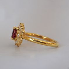 Indulge in timeless romance with the Rosaire spinel ring. Featuring a vibrant spinel center stone in a French-inspired setting, this ring captures and reflects light beautifully, reminiscent of Parisian nights. Crafted with delicate filigree, the Rosaire exudes elegance and vintage charm, making it the perfect symbol of eternal love. Ideal as a gift or a cherished addition to your collection, this stunning ring is a true treasure. All orders come in our Tippy Taste ring box. This ring is handmade and designed in NYC. 14K or 18K solid gold Natural oval red spinel, 5*4mm 12 Natural round diamonds. SI clarity, GH color, 0.1ct total carat weight 1.5mm ring band ** Tippy Taste Heirloom Collection is made to order. Please allow 3-4 week turnaround time. Shipping:Domestic: Free shippingInternatio Elegant Yellow Gold Sapphire Ring With Halo, Heirloom Gold Tourmaline Ring, Timeless 14k Gold Ruby Wedding Ring, Elegant Gold Sapphire Ring With Halo Design, Elegant Ruby Cluster Ring With Rose Cut Diamonds, Heirloom Yellow Gold Sapphire Ring With Halo, Elegant Yellow Gold Sapphire Ring With Halo Design, Elegant Ruby Wedding Ring With Halo, Elegant Yellow Gold Tourmaline Birthstone Ring