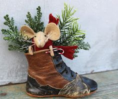 a brown and black shoe with a mouse in it's boot hanging from the side