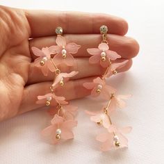 When you want your drop earrings to not just drop but plunge, these lightweight pretty blossom earrings will really steal the show and with 3 colours to choose from, you'll be able to match these perfectly with your fairy pastels. Each flower bead has a pretty imitation pearl nestled within, the colourful flowers hang down from each pin in a jaunty zig-zag formation. Each earring has 6 flowers to move and sway, framing your face with floral beauty.  Miss Kitsch UK shop: misskitschuk.etsy.com ♥ USEFUL INFORMATION ♥ ♦ Postage - UK - 2nd class post. Estimated delivery 2-3 days. In rare cases (outside of my control!) this can take up to 10 working days to arrive. If the order is urgent or is a gift for a certain date, it's recommended you pick one of the priced postage options at checkout. ♦ P Feminine Drop Earrings For Spring, Summer Jewelry With 3d Flower Shapes, Spring Flower Jewelry With 3d Flowers, Spring Flower Shaped Jewelry With 3d Flowers, Spring 3d Flowers Dangle Earrings, Feminine Flower-shaped Earrings For Gifts, Delicate Flower Earrings For Spring, Dainty Spring Flower Earrings For Pierced Ears, Drop Earrings For Spring Wedding