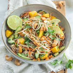 a bowl filled with noodles and vegetables on top of a table