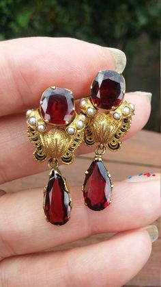 Stunning Victorian Jewelry Set, circa 1920's, from Estate Sale, 14k Gold, Garnet Seed Pearl, Black Enamel Earrings and Brooch...The Brooch is 35mm x 40mmEarrings is 35mm x 15mmTear Drop Garnet is 15mm x 8mm Garnet is Matched perfectly well, Color is Outstanding, super clean, just finger prints, sorry....Weight is 15.3 Grams.All Dimensions, Measurements and description is ApproximatelyPerfect Antique condition.Layaway plan is available Victorian Oval Jewelry For Opera, Victorian Gold Jewelry For Opera, Vintage Gold Jewelry For Opera, Victorian Hallmarked Jewelry For Opera, Victorian Baroque Formal Jewelry, Wedding Jewelry With Screw Back, Antique Gold Jewelry For Opera, Victorian Baroque Earrings For Formal Occasions, Art Deco Clip-on Jewelry For Formal Occasions