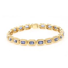 This is part of Chairish’s Fine Jewelry assortment.  Tanzanite gemstone tennis bracelet in 14K gold. It has a perfect octagon cut gemstone to make you stand out on any occasion or an event. Tanzanite facilitates higher concentration. Featuring 6.01 cts of tanzanite mounted with solid 14K gold, this handcrafted tennis bracelet makes an excellent wedding gift for anyone on your list.  PRODUCT DETAILS :-  Material - 14K Solid Yellow Gold Gemstone - Tanzanite  Stone Weight - 6.01 ct Stone Shape - Octagon  Stone Pcs - 20 Stone Size - 5 x 3 mm Gross Weight - 12.495 Grams Setting - Bezel setting Length - 7 inch  Width - 6 mm Classic Emerald Cut Jubilee Bracelet, Classic Gold Emerald Cut Tennis Bracelet, Yellow Gold Emerald Cut Tennis Bracelet For Formal Occasions, Emerald Cut Yellow Gold Tennis Bracelet For Formal Occasions, Emerald Cut Yellow Gold Tennis Bracelet For Formal Events, Elegant Emerald Cut Yellow Gold Tennis Bracelet, Formal Yellow Gold Emerald Cut Tennis Bracelet, Elegant Yellow Gold Rectangular Tennis Bracelet, Elegant Octagon Diamond Bracelet For Formal Occasions