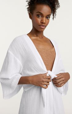 Introduce summer chic with the Ralpha Top from our à la plage collection! This flouncy, white cover-up showcases a tie detail that adds a hint of elegance and will make you look stunning while pool or beach-side. It's more than just a fashion must-have - it's a summer necessity! Will you be ready? Details Tie closureFabric: Cotton gauzeTie details Content and Care 100% CottonDry CleanImported Measurements 35in/88.9cm, From shoulder to hemMeasurements from size 4 White Open Front Swimwear For Beach Cover-up, Chic Unlined Spring Cover-up, Chic Spring Unlined Cover-up, Chic Summer Wrap Cover-up, White Breezy Cover-up For Vacation, White Flowy Cover-up For Vacation, White Open Front Swimwear For Beach Season, White Wrap Cover-up For Spring, White Breezy Summer Cover-up