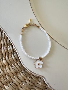 White and gold flower baby bracelet | Baby shower present | Baby bracelet | Baby girl bracelet | Flower bracelet charm West Wood Sign Co D E T A I L S: Gold Plated clasp and chain P L E A S E  R E A D: When measuring wrist add 1/2 inch! All items are handmade and slight variations may occur with each piece.  Follow us on Instagram @WestWoodSignCo https://www.etsy.com/shop/WestWoodSignCo Girl Bracelet, Cadeau Baby Shower, Bracelet Flower, Birthday Flower, Baby Shower Presents, Baby Bracelet, Girl Jewelry, Star Bracelet