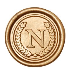 a gold wax seal with the letter n in it's center and two wreaths on