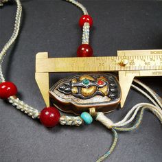 This portable Gau shrine was handcrafted by Tibetan artisans from Hepo Township, Baiyu County. Its theme is mani jewel, a treasure vase on a lotus base, inside the vase are mani jewels and other jewels.Each exquisite pattern on it is meticulously hand-carved,and it is embellished with the technique of gold inlay, with cold iron and pure silver inlaid on the red copper material and gold-plated on the pure silver material,inlaid with turquoise and agate bead. This technique is highly intricate and Buddhist Altar, Red Copper, Tibetan Buddhist, Copper Material, Silver Material, Agate Beads, Turquoise Beads, Pure Silver, Lotus