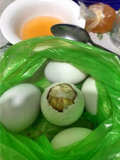 an egg is in a green bag next to other eggs