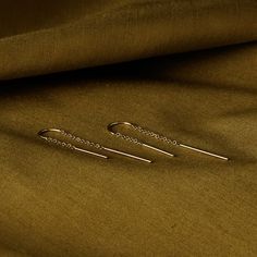 This is the perfect thread through earring. Its length allows for easy everyday wear that withstands work, workouts, and weddings. It has a curved, solid gold bar in the middle that allows the earring to stay in place so it never threads back and forth and always sits right in place. Modern Nickel-free Threader Earrings, Gold Nickel-free Threader Earrings, Modern 14k Gold-filled Gold Threader Earrings, Delicate 14k Gold-filled Threader Earrings, Gold 14k Gold-filled Threader Earrings With Adjustable Chain, Sell Gold, Gold Bar, Chain Earrings, Thread