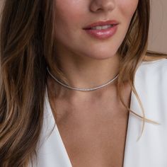 Give the gift of sparkle this holiday season with our Diamond Tennis Choker Necklace. Featuring dazzling diamond gemstones on a delicate chain, this versatile piece adds elegance to any look—from casual outings to glamorous date nights. A perfect Christmas gift to make someone shine. SKU: RR-NR152 Product Details Finish/Material: 18K Gold Over Brass ∙ Rhodium Over Brass, CZ Diamond Gemstones Featuring a Dainty ~2mm CZ Diamond Tennis Choker Necklace, available in 2 lengths: 14 Inches + 2 Inch Ext Crystal Tennis Necklace With Diamond Cut, Dazzling Diamond-cut Tennis Necklace, Silver Minimalist Tennis Necklace For Anniversary, Minimalist Silver Tennis Necklace For Anniversary, Fine Jewelry White Gold Necklace With Jewels, Elegant Diamond White Necklaces With Jewels, White Gold Jeweled Fine Necklaces, Dazzling Round Diamond Necklace With Jewels, Dazzling Round Diamond Necklace