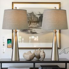 two lamps sitting on top of a table