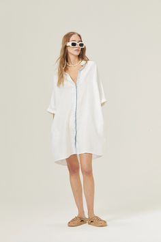 The Lighthouse Shirt Dress is the perfect style that you'll take to the beach and for running your daily errands, while looking stunning in the process. It's made with our signature premium linen, which is pre-washed and softened, resulting in a super soft touch and effortless handling. This easy shirt dress exudes a resort vibe, featuring a Mandarin collar and shell buttons. The contrasting printed details add a playful touch to this style.DETAILSPremium 100% organic linen fabricOne SizeShort l V-neck Shirt Dress For Summer Beach, White V-neck Shirt Dress With Relaxed Fit, Summer V-neck Shirt Dress For Beach, Chic White Summer Shirt Dress, White Chic Shirt Dress For Summer, V-neck Shirt Dress For Beach Daywear, Chic White Shirt Dress For Summer, V-neck Relaxed Fit Shirt Dress For Vacation, Relaxed Fit V-neck Shirt Dress For Vacation