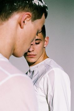 two young men standing next to each other