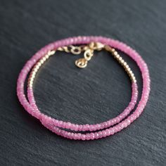 "Want to save 15% off your first order? Sign up for our newsletter by visiting our website and filling out the pop up form. Receive a code by email, then send us that code through Etsy messages to save 15% off your ETSY order, sign up here: www.earthlyabundancejewelry.com  Pink Sapphire: spiritual evolution, growth, self-reliance, love Dainty pink sapphire choker necklace, with 14K gold filled components. D E T A I L S △ Handmade in Vancouver △ Rondel faceted cut △ 2.5-3mm [gradient] △ AAA+ Pink Pink Rondelle Jewelry With Faceted Beads, Pink Faceted Rondelle Beads Jewelry, Pink Tiny Beads Round Jewelry, Pink Round Jewelry With Tiny Beads, Pink Round Beaded Jewelry, Pink Rondelle Jewelry, Sapphire Choker, Pink Sapphire Necklace, Necklace Sapphire