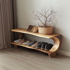 there are many pairs of shoes on the wooden shelf next to the planter and window