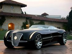 a black car parked in front of a house