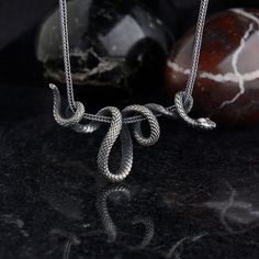 Snake silver pendant necklaces is carefully designed and hand-made for you. We presented the pendant as white bronze (silver plated) or 925 sterling silver. Suitable for daily use and at the same time very stylish, this necklace can be an anniversary gift or commemorative gift to your loved ones and will come neatly packaged as a gift. As NuaSilverRings, we guarantee that we will help you with all your problems. Materials : - 925 Sterling Silver - White Bronze (silver plated) Note: If you buy wi Gothic Pendant Necklace With Silver Chain, Black Snake-shaped Necklaces As Gift, Snake-shaped Metal Necklace For Gift, Unique Silver Snake-shaped Necklace, Gothic Pewter Pendant Necklace, Snake Pendant, Snake Necklace, Delicate Jewelry, Unique Pendant