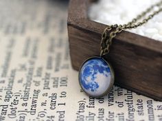 Beautiful and unique, Space necklace, featuring an image of a Blue Moon. A great gift for you or anyone in love with the night sky and the Solar system! Chain length is 48cm/19" and the diameter of the image is 16mm. ☀ You can see more from Sun and Stars Jewelry here - sunandstarsjewelry.etsy.com⋆ More Space Jewelry - https://www.etsy.com/shop/SunAndStarsJewelry?section_id=14349961&ref=shopsection_leftnav_1----------------------------------------------------☀ Product care:⋆ avoid contact wit Blue Full Moon, Blue Moon Necklace, Stars Jewelry, Full Moon Necklace, Space Necklace, Moon Full, Moon Space, Galaxy Jewelry, Moon Blue