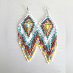 the beaded earrings are hanging from hooks