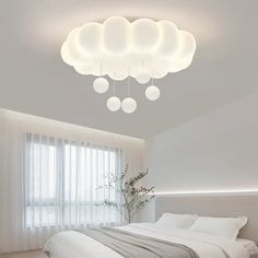 a bedroom with a large bed and several lights hanging from it's headboard