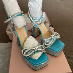 Brand, New Ocean Blue Platform, Satin Double Bow Sandals, 144 Mm Please Examine Picture Carefully. One Of The Heels Is Missing Some Rhinestones. These Are Brand New, Never Been Worn. Comes With The Original Box And A Dust Bag Luxury Blue Sandals For Cocktail, Blue High Heel Sandals For Cocktail, Blue Ankle Strap Sandals For Cocktail, Spring Blue Cocktail Sandals, Blue Block Heel Sandals For Party, Blue Party Sandals With Block Heel, Blue Open Toe Sandals For Cocktail, Blue Sandals With Heel Strap For Party, Light Blue Ankle Strap Sandals For Evening