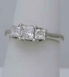 Description Ladies 14k White Gold (not plated or filled) 1.00ct Princess Cut Diamond Three Stone Engagement Ring! GORGEOUS RING! So much nicer in person! Diamond have amazing brilliance and sparkle in person! For diamond color and clarity please see grading below and don't base on the photos as diamonds are hard to capture on camera. Features: FREE appraisal upon request FREE Fedex 2nd day shipping FULLY INSURED Weight: 2 grams Width: 5.4mm Height: 7mm including prongs Diamonds: 3 Princess Cut N Gia Certified Marquise Cut White Jewelry, Gia Certified White Marquise Cut Jewelry, White Gia Certified Marquise Cut Jewelry, Gia Certified Marquise Cut Cubic Zirconia Wedding Jewelry, Gia Certified Marquise Cut Cubic Zirconia For Wedding, White Marquise Cut Gia Certified Diamond Ring, Gia Certified Marquise Cut Lab Grown Diamond Jewelry, Gia Certified Lab Grown Diamond Marquise Cut Jewelry, Gia Certified Diamond White Diamond Ring