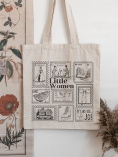 a tote bag sitting on top of a table next to some flowers and pictures