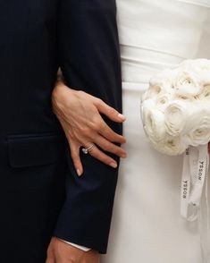 the bride and groom are holding their wedding bouquet