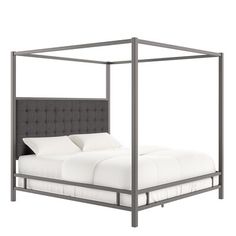 a bed with a gray frame and white sheets