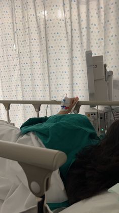 a person laying in a hospital bed with an iv machine on top of it's head