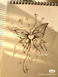 a drawing of a butterfly with hearts on it's wings is shown next to an open book