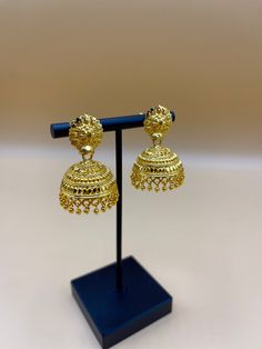 Indulge in the timeless allure of our 24k Polished Earrings, a true embodiment of elegance and luxury. Meticulously handcrafted by skilled artisans from Nepal, these exquisite earrings are crafted from pure 24k gold, radiating a lustrous and polished finish. The intricate detailing and traditional designs pay homage to  rich cultural heritage, making each piece a work of art. Elevate your style and make a statement with these opulent earrings, a perfect accessory for special occasions or adding 22k Gold Dangle Jhumkas For Wedding, Temple Jewelry Tilla Jhumkas, Traditional 22k Gold Bridal Earrings For Festive Occasions, Traditional Intricate Dangle Jhumkas, 22k Gold Dangle Jhumkas For Festive Occasions, 22k Gold Chandbali Bridal Earrings With Latkans, Festive 22k Gold Drop Earrings, Wedding 22k Gold Danglers, 22k Gold Chandbali Danglers With Latkans