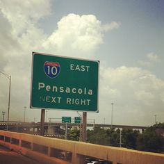 an interstate exit sign on the side of a highway