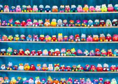 a shelf filled with lots of different colored stuffed animals