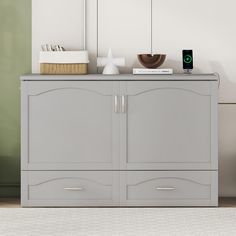 a gray cabinet with two drawers and a phone on top