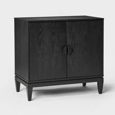 a black cabinet with two doors and one drawer