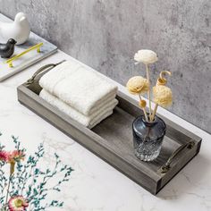 a tray with towels and vases on it