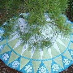 a pine tree branch on top of a quilt