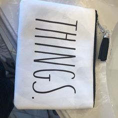 a white and black zippered pouch sitting on top of a table