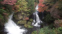 a waterfall surrounded by trees in the fall