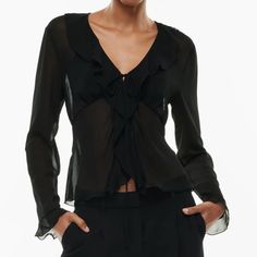 This Is A V-Neck Blouse With Ruffled Edges And A Tie Closure. It’s Made With Fte Chiffon Lightweight, Semi-Sheer Fabric With An Ethereal Drape. This Version Is Made From 100% Recycled Materials. Features Unlined For A Sheer Look Materials & Care Content: 100% Recycled Polyester Care: Machine Wash Imported Fit: Classic Follows Your Contours With A Little Room Length: Waist Intended To Hit Between The Waist And High Hip Bust 30 1/2 In Waist 22 1/2 In Formal V-neck Blouse With Ruffles, Elegant V-neck Top For Night Out In Spring, Spring V-neck Blouse For Night Out, V-neck Ruffle Blouse For Night Out, Elegant Viscose Blouse For Night Out, Elegant Ruffled V-neck Blouse, Elegant V-neck Ruffle Blouse, Sheer V-neck Blouse For Work, Sheer Fitted V-neck Blouse