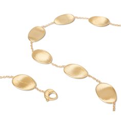 The Lunaria Collection is a line born from Marco's love of nature. Crafted entirely of hand-engraved, 18-karat yellow gold plates framed by polished gold and hand-molded by expert craftsmen, the collection resembles the gentle movement of petals blowing in the wind. The alternating sequences of plates yield lustrous necklaces, bracelets, earrings, and rings that translate into elegant and refined styles. MATERIAL: 18K Yellow Gold LENGTH: 18 inch Please Note: All our pieces are handmade and uniqu