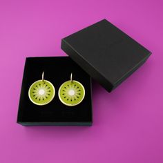 These perfect circles of symmetry scream fun in a delightfully juicy way. A beautiful combination of greens, the flashes of gold and pearly white add to the elegance of this kiwi earring.  The kiwis hang and sway from elegant 22mm gold-filled hoops, and are removable so you can wear the hoops on their own—two earrings in one, perfect for travel! Wipe clean with a damp cloth. Do not submerge in water. Keep away from extreme heat. Kiwi Earrings, Frosted Mirror, Daisy Charm, Hoop Charms, Gold Filled Hoops, Juicy Fruit, Extreme Heat, A Perfect Circle, Independent Designers Fashion