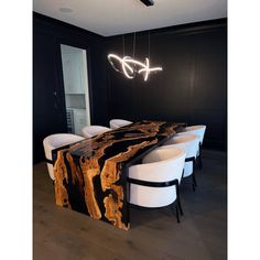 a dining room table with chairs and a large slab of wood