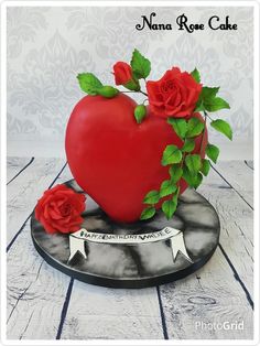 there is a heart shaped cake with roses on it