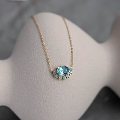 Art deco necklace with Swiss blue topaz gemstones in 14K solid gold for women and girls. The gemstone are natural. Topaz jewelry is a great choice for a birthday gift for her or a Christmas gift, as topaz is the December birthstone. 100% handcrafted with love! ● Metal: 14K solid gold ● Gemstone: Swiss Topaz, oval and round cut ● Stones' Dimensions: oval 9 x 7mm, round 2mm ● Weight: Oval 2.24ct, Round 0.35ct ● Length: 16 inches G I F T S All our pieces are delivered beautifully packaged and gift ready with a certificate of authenticity for the metal and the stone. P R O D U C T I O N ∙ T I M E * S H I P P I N G * P O L I C I E S Please keep in mind that each item is handcrafted and we need 5 days at least for its production. If you need your order on a specific date, please contact us. All Topaz Pendant Necklace, Oval Blue Topaz Sapphire Necklace, Fine Jewelry Oval Topaz Necklaces, Yellow Gold Topaz Oval Necklace, Oval Blue Topaz Necklace, Oval Topaz Birthstone Necklace, Blue Oval Topaz Necklaces, Blue Topaz Oval Necklaces, Blue Topaz Oval Pendant Necklace For Anniversary