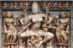 an intricately carved wooden sculpture depicting the hindu goddesss and their attendants, possibly from india