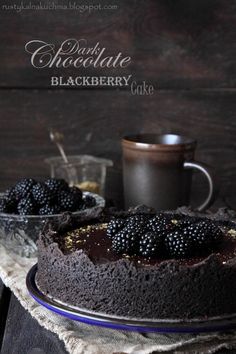 a chocolate cake with blackberries on top