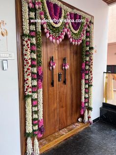 an entrance decorated with flowers and garlands